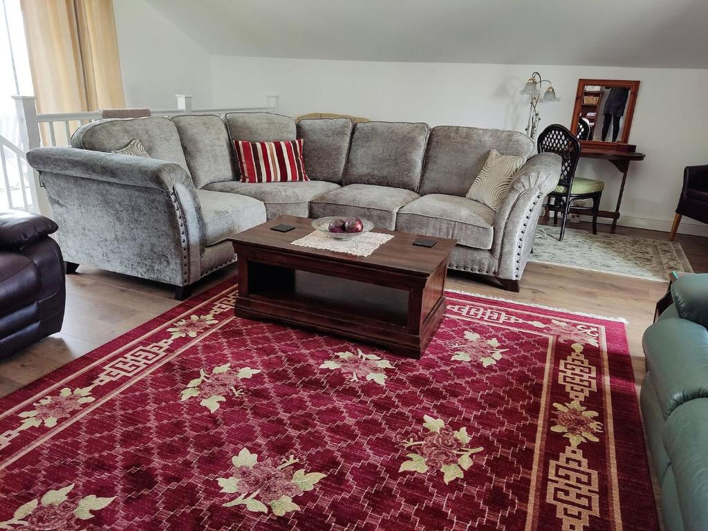 a living room with a couch and a coffee table at Kingford Lodge in High Bickington