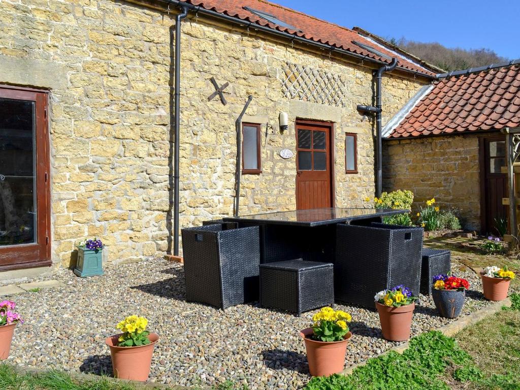 a ping pong table in front of a stone building at Whisperdale Barn in Broxa