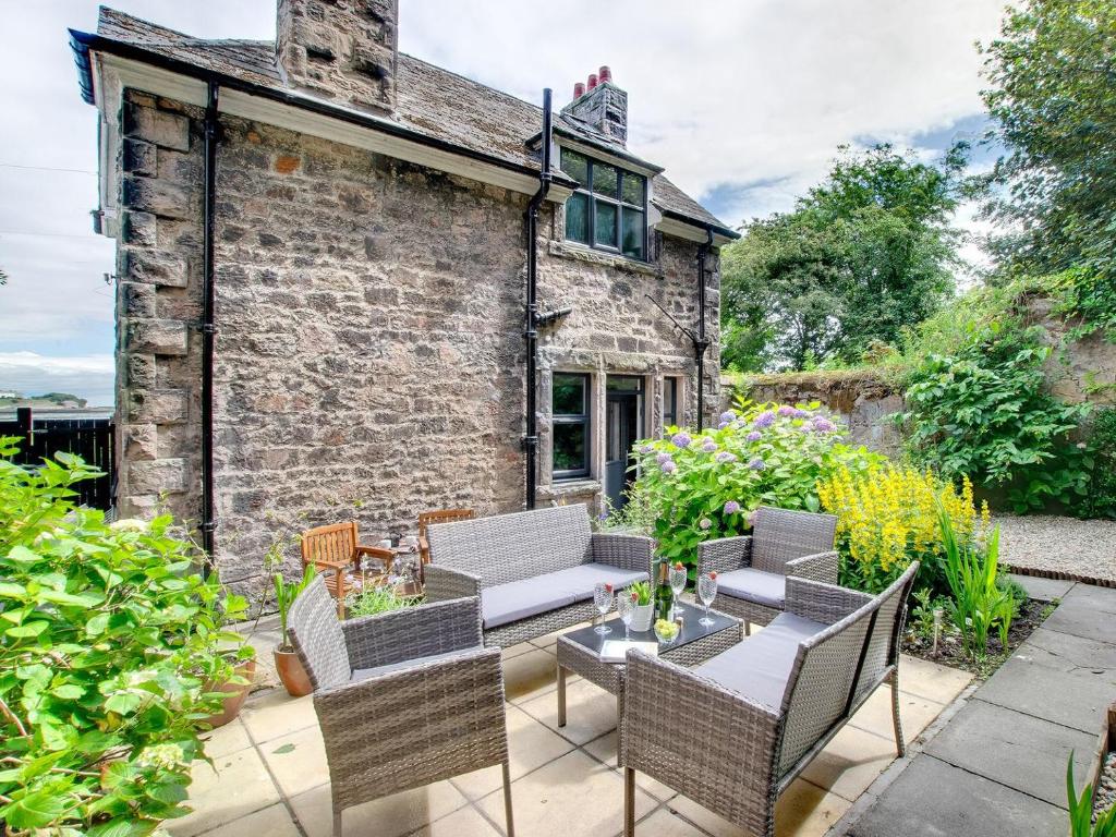 a patio with chairs and a table in front of a building at Heron House in Tweedmouth