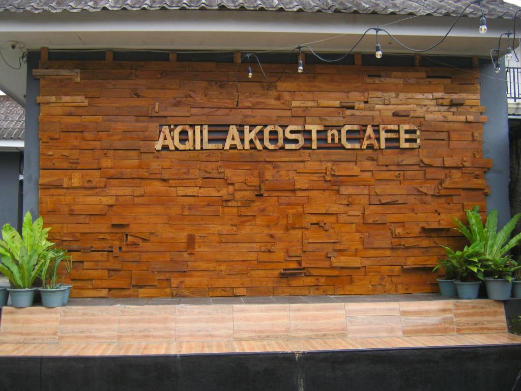 a brick wall with a sign on it at Aqilakost n Cafe Gadog Puncak in Bogor