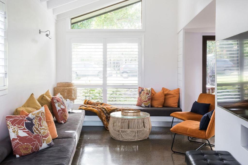 a living room with a couch and a window at The Coconut Palm TWO in Sunshine Beach