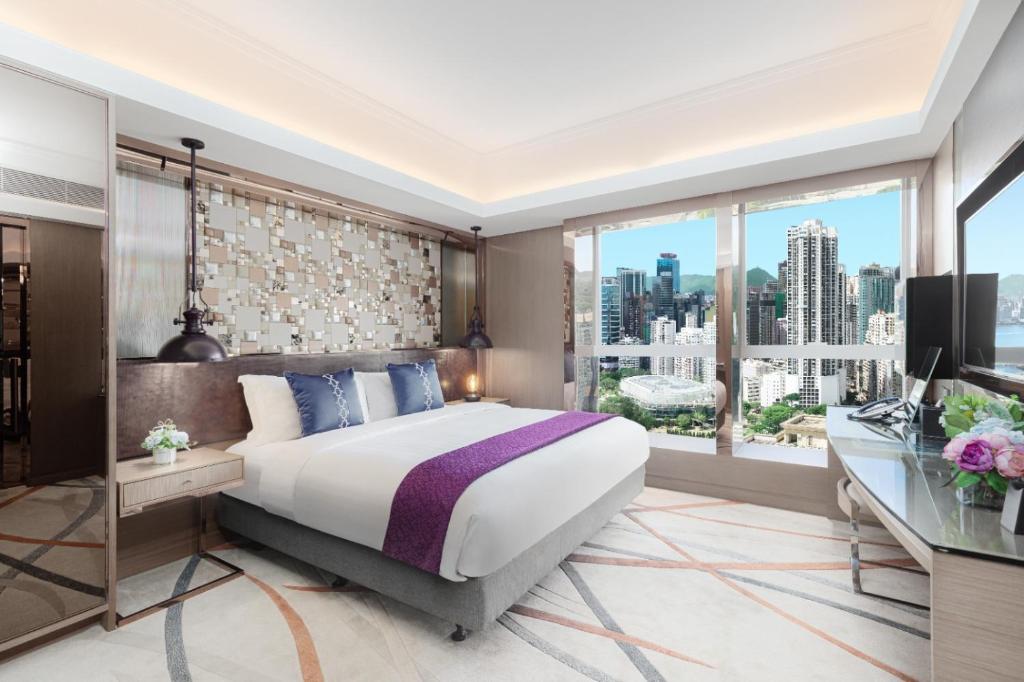 a bedroom with a large bed and a large window at Metaplace Hotel in Hong Kong
