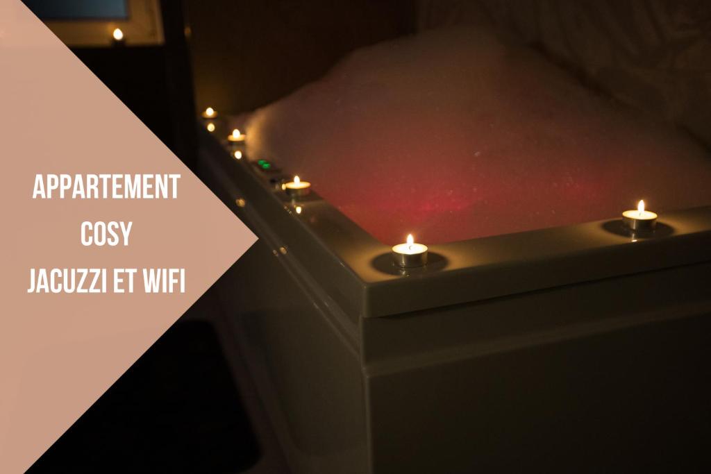 a pair of candles with a sign that reads apartment csis javascript left wifi at ODYSSEE l'expérience commence ici JACUZZI in Saint-Jean-Bonnefonds