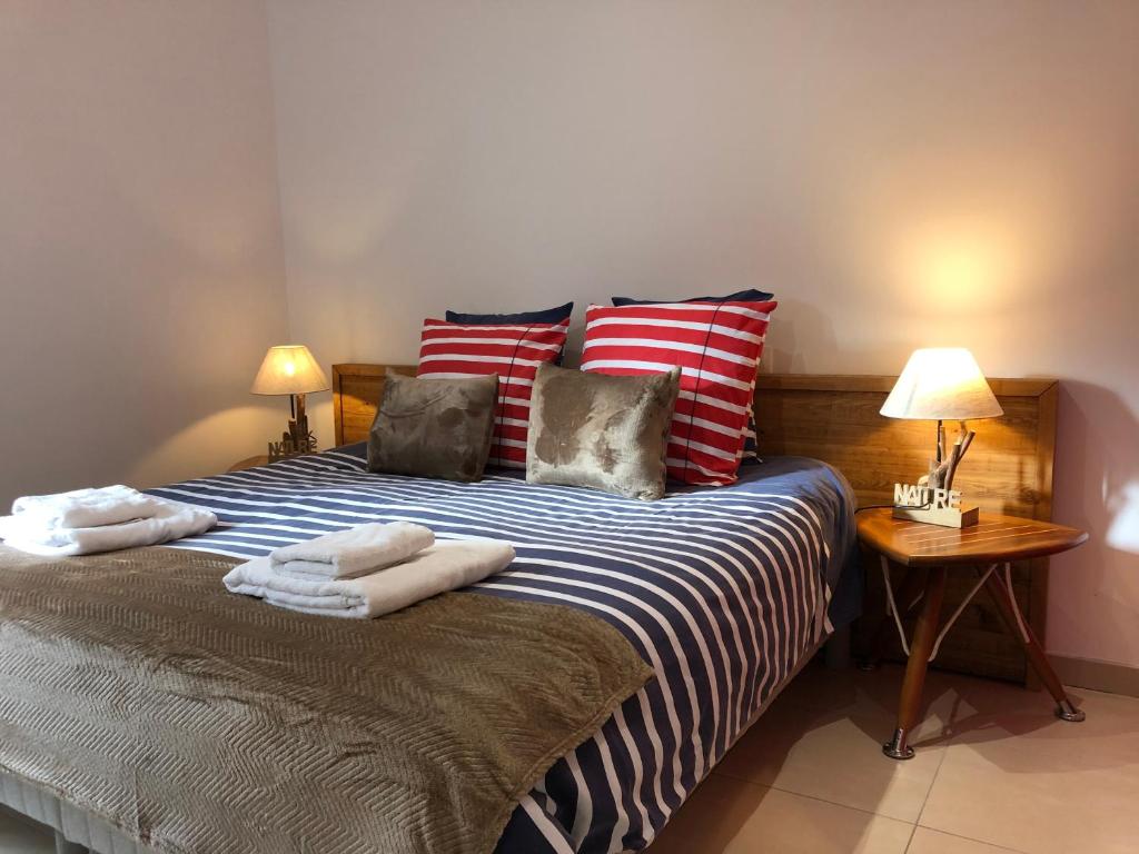 a bedroom with a bed with towels on it at Le clos du square in Rochefort