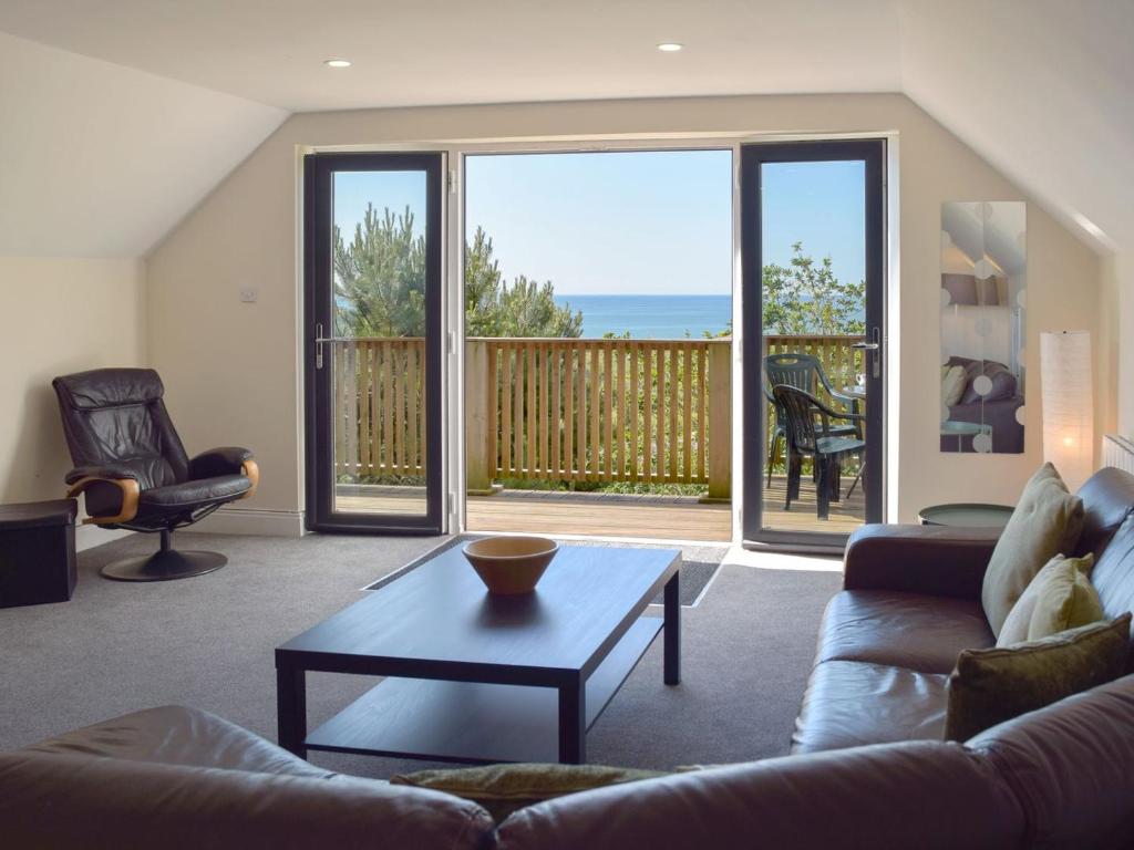 a living room with a couch and a coffee table at The Gate House in Pendine