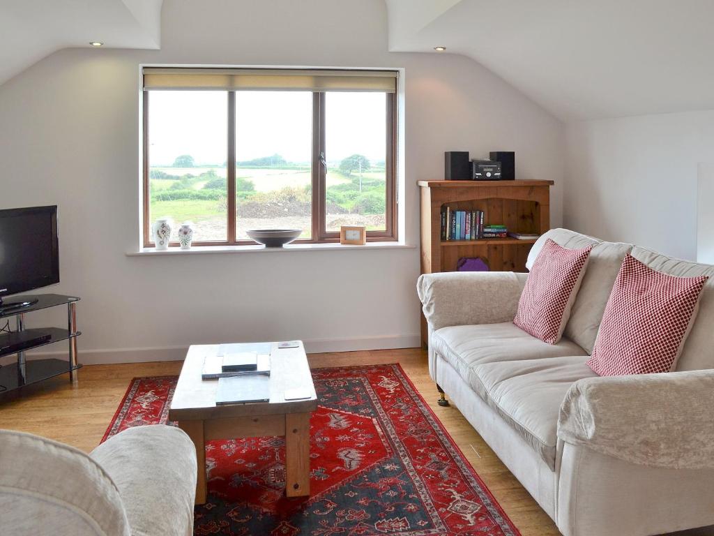 a living room with a couch and a table at Bryn Menai - Hw7573 in Llanddeiniolen