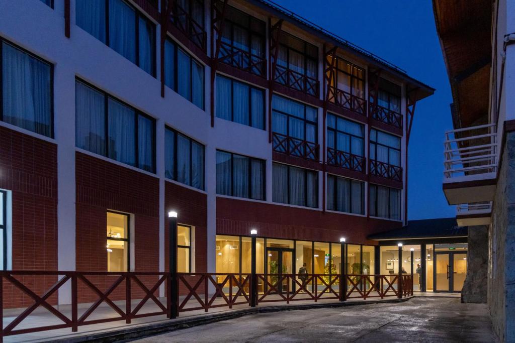 an exterior view of a building with a balcony at Hotel 1700 in Bakuriani