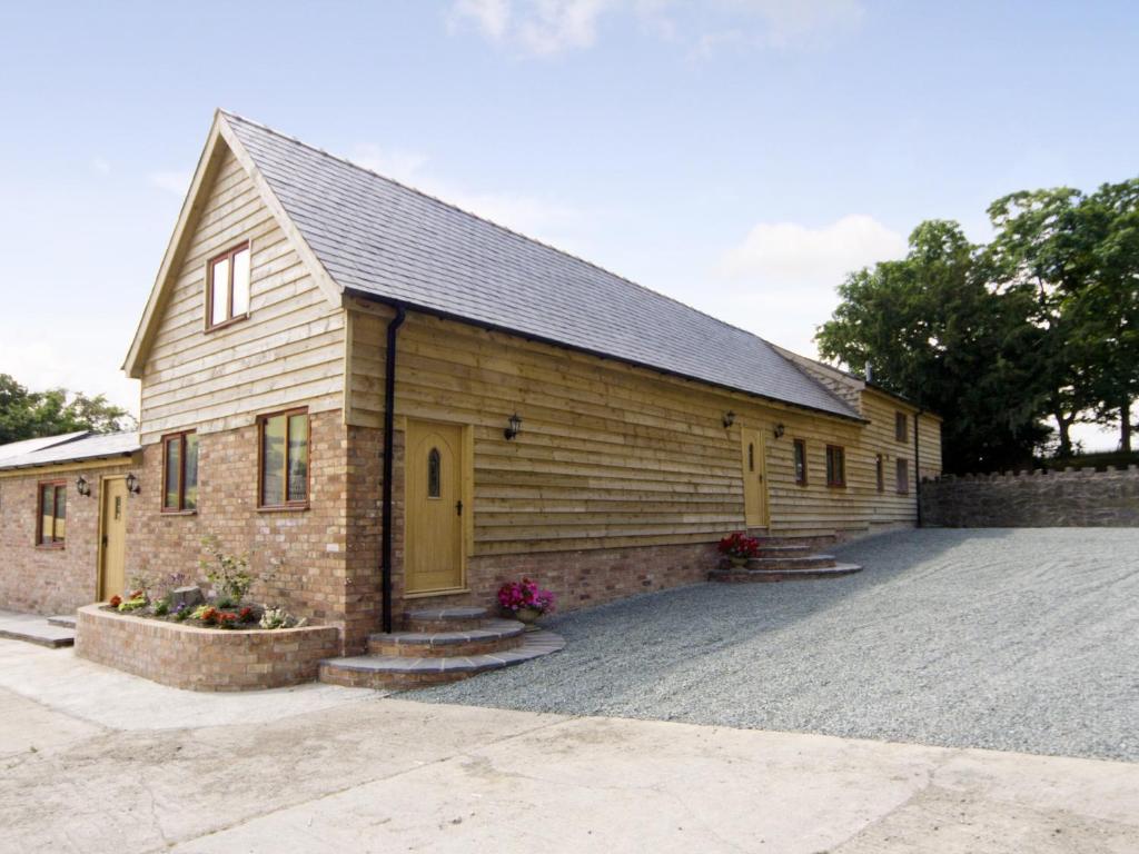 a large wooden church with a yellow door at Cefnaire Isaf in Newtown