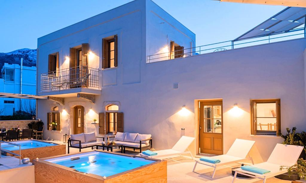 a villa with a swimming pool and a house at Sun Stone Villas in Chania