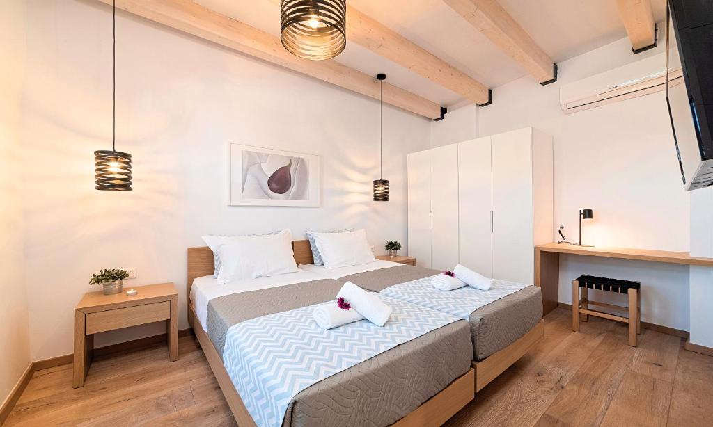 Postel nebo postele na pokoji v ubytování Sun Stone Villas
