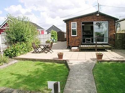 a small house with a yard with a patio at Summer Time in Brundall