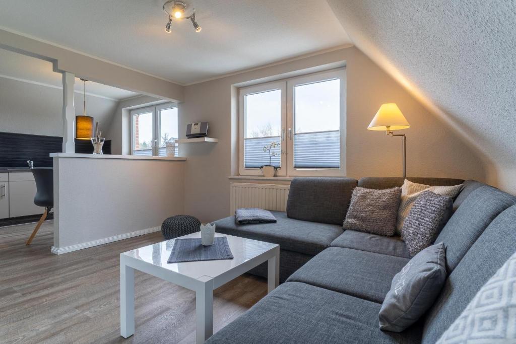 a living room with a couch and a table at Duenenzauber in Olsdorf