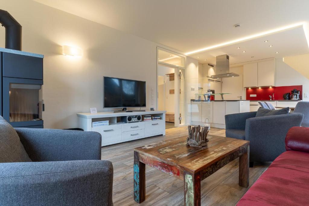 a living room with a couch and a table at Wohnung-Windboee in Sankt Peter-Ording