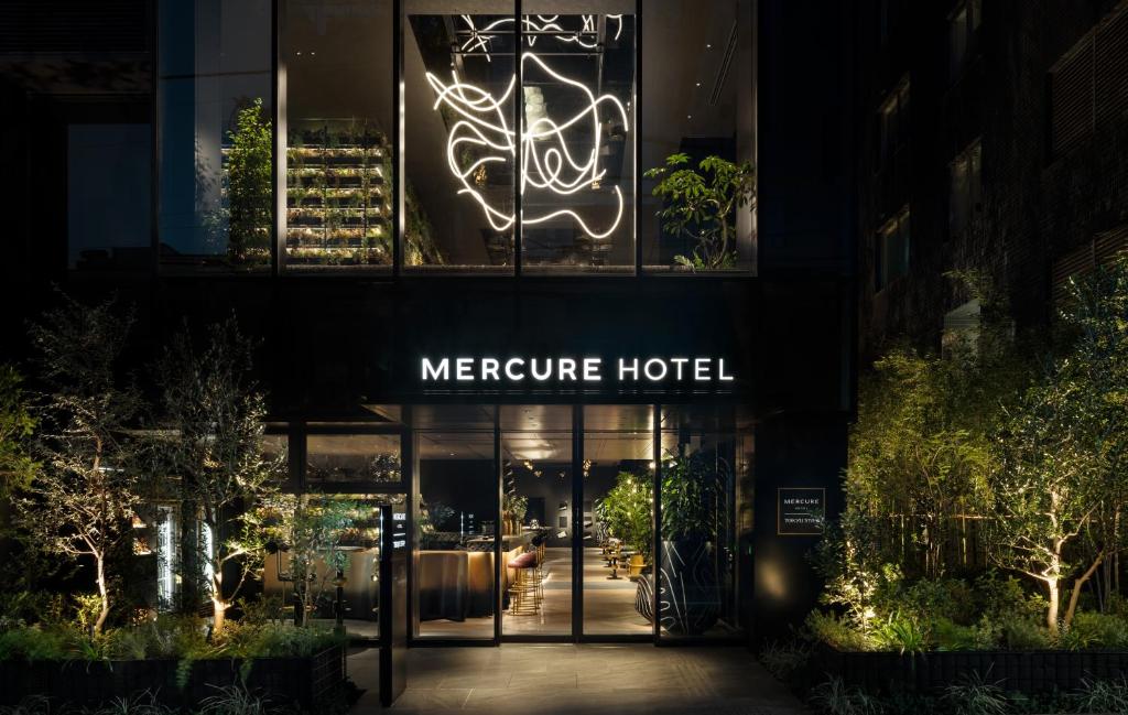 a meerreute hotel at night with a neon sign at Mercure Tokyu Stay Osaka Namba in Osaka