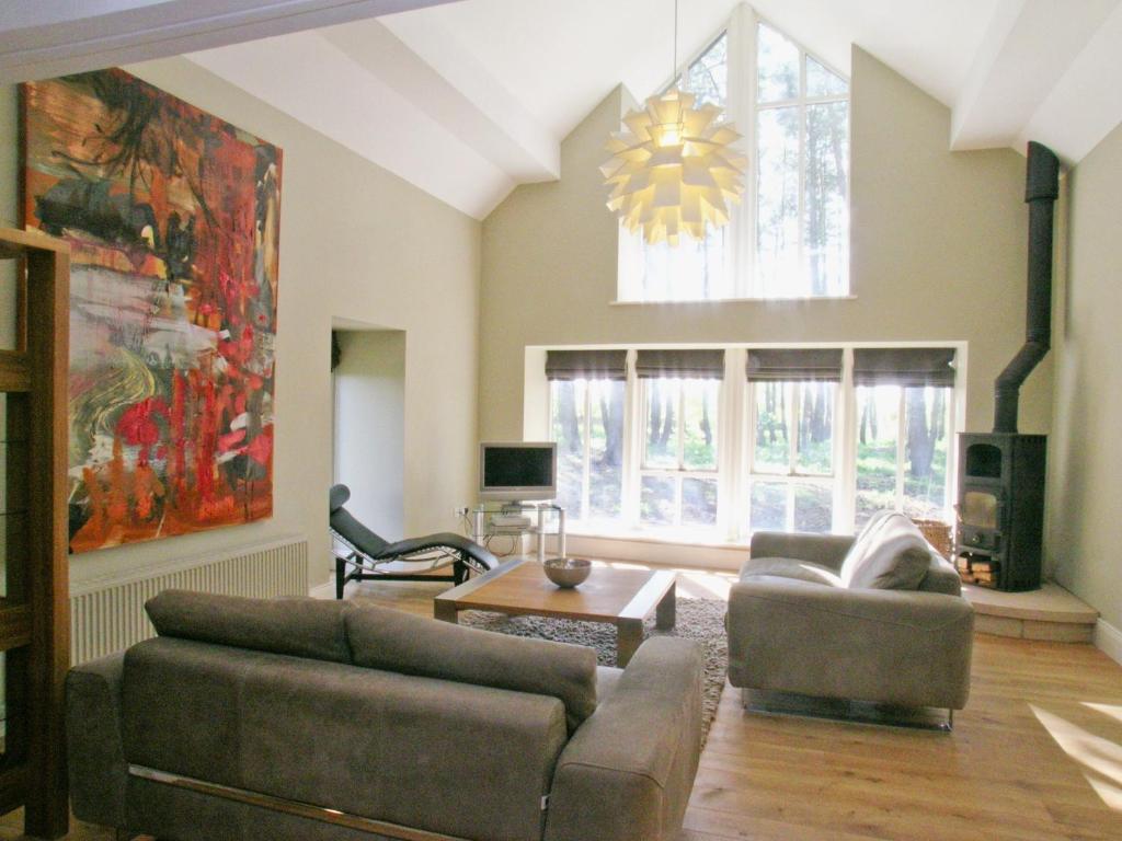 a living room with a couch and a table at The Bothy House in Berwick Hill