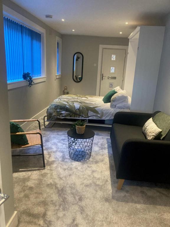 a living room with a bed and a couch at Teviot View Apartment in Hawick