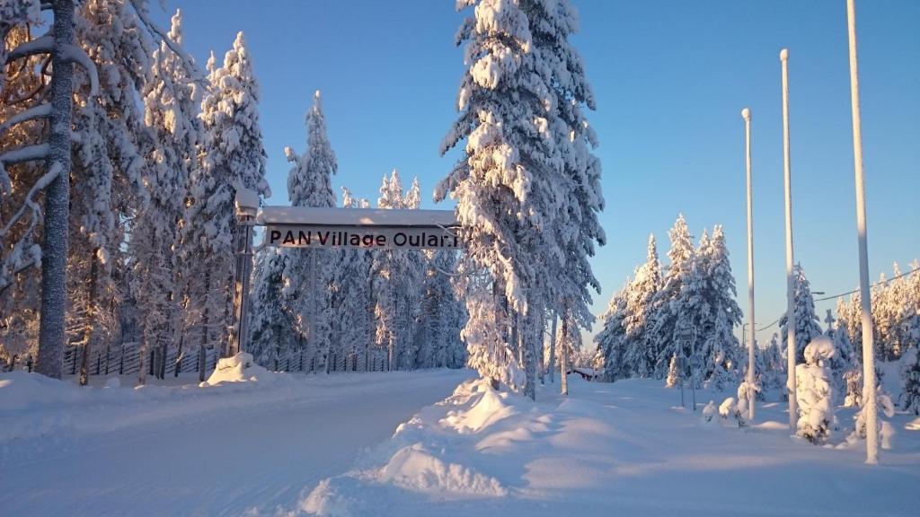 a sign for a ski village outlet in the snow at Sallainen Panvillage in Salla