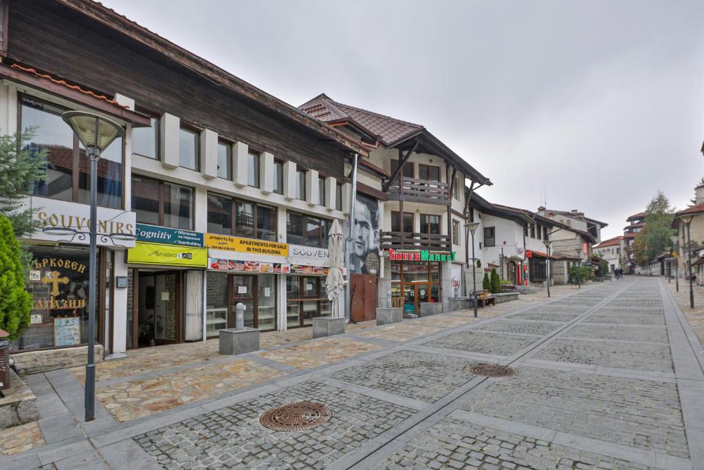 an empty street in a town with buildings at Pirin Studios in Bansko