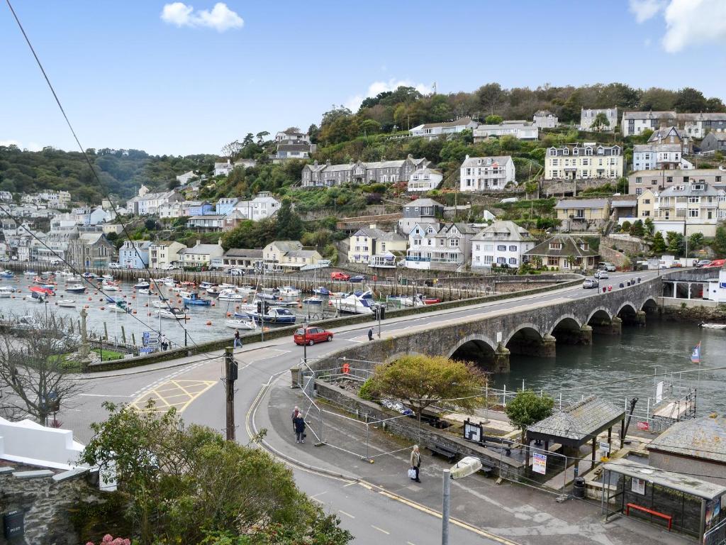 a city with a bridge and a river with cars at Sunrise in Looe