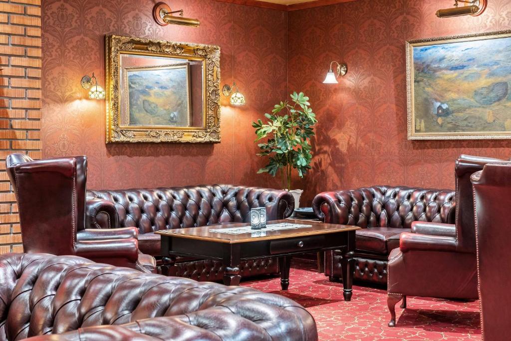 una sala d'attesa con divani in pelle e tavolo di Best Western Laegreid Hotell a Sogndal