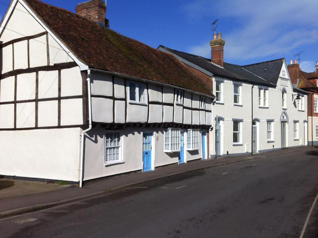 a row of white buildings on the side of a street at Tudor Cottage in Romsey