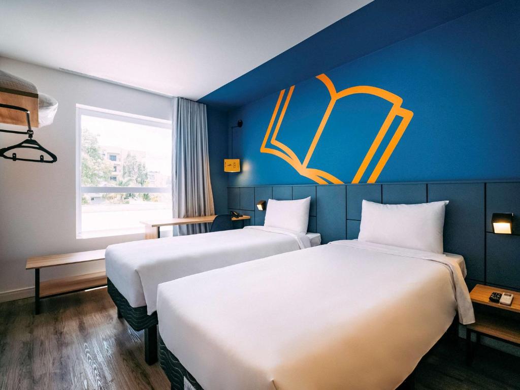 Postel nebo postele na pokoji v ubytování ibis Styles Poços de Caldas