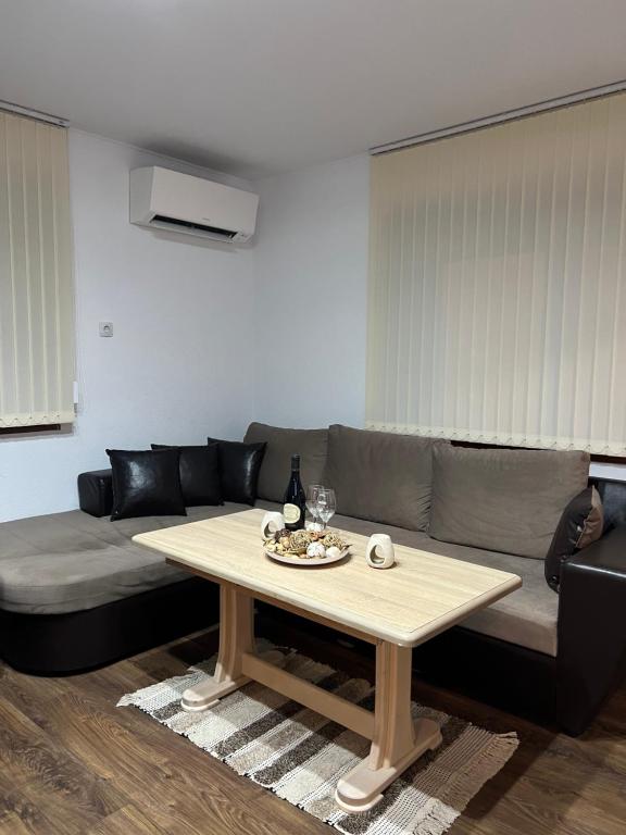 a living room with a couch and a table at Guest House Tanevi in Devin