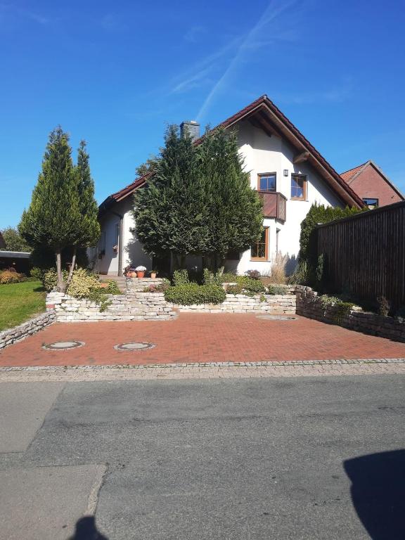 a house with a brick driveway in front of a house at FeWo oben in Kalletal