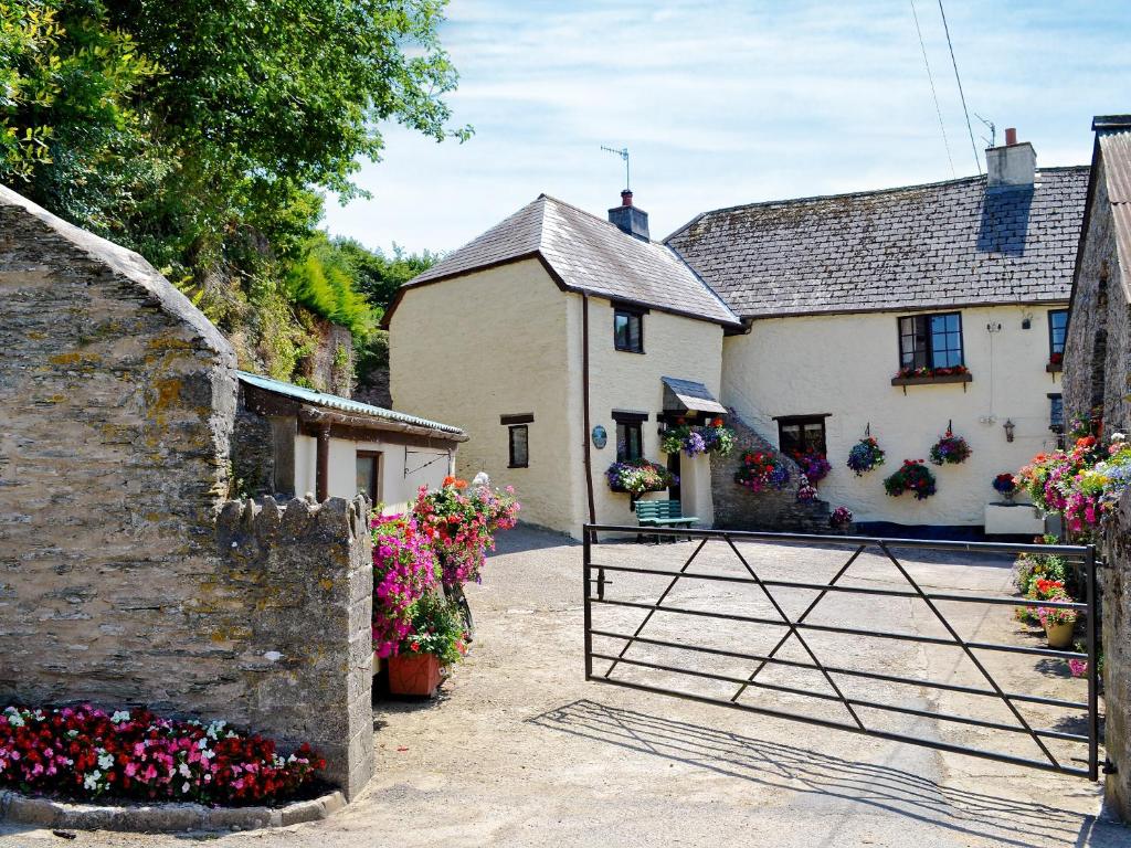 a white house with a gate in front of it at Fordbrook Cottage in Brixton