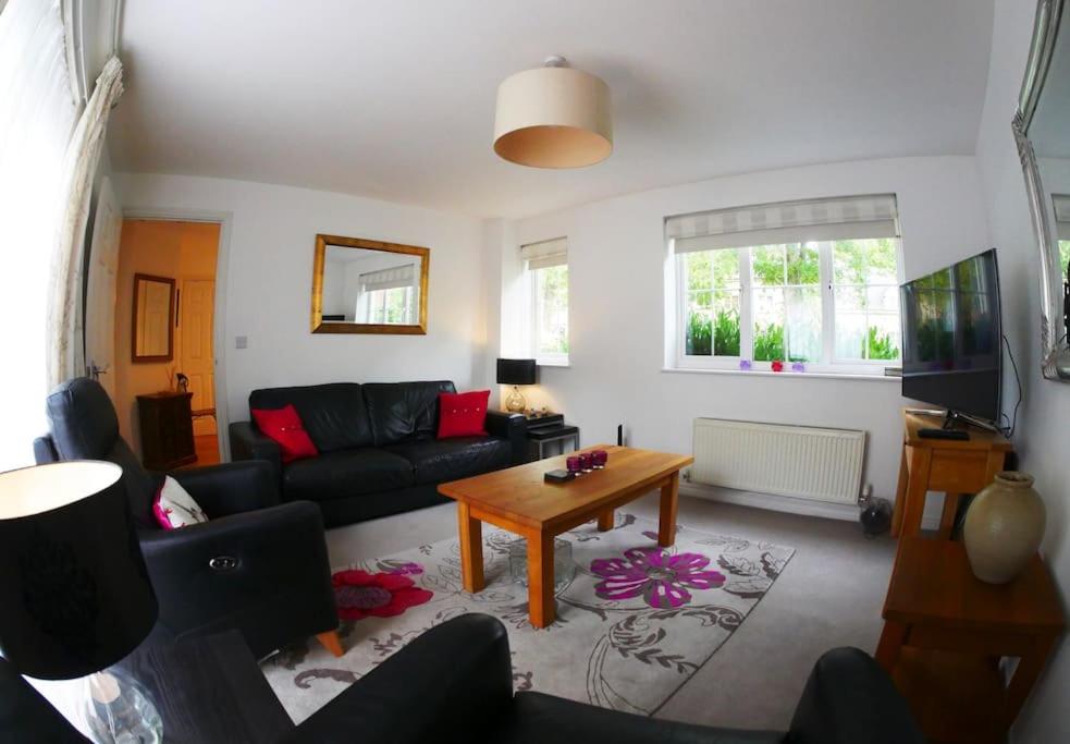 a living room with a couch and a table at Self contained Stylish 3 Bed Home in Great Plumstead