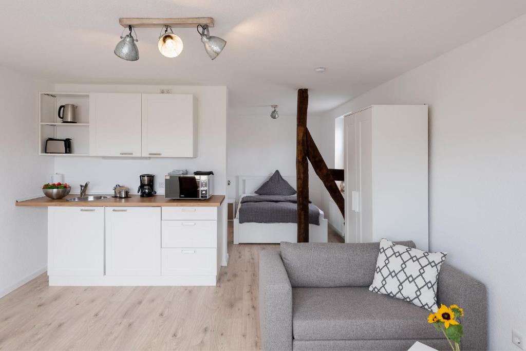 a living room with a couch and a kitchen at Gästehaus Hegerweg 2, Calden in Calden