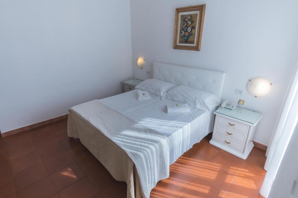 Postel nebo postele na pokoji v ubytování Hotel Victoria