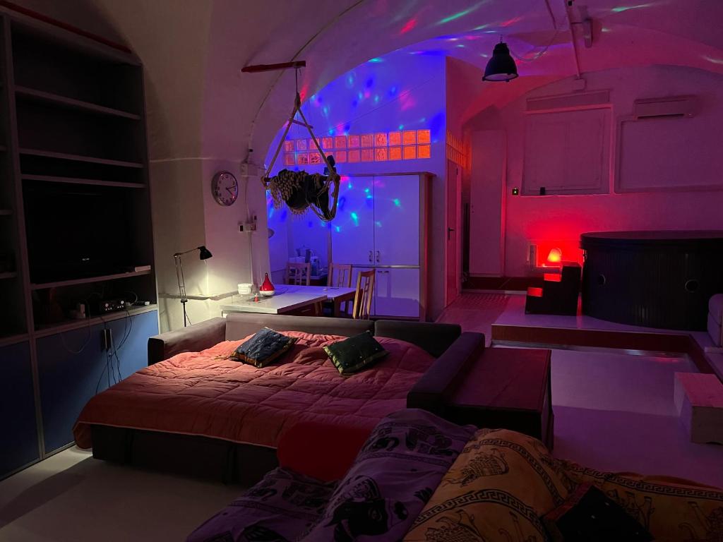 a bedroom with a bed and a purple lighting at Ilsoleresort in Genova