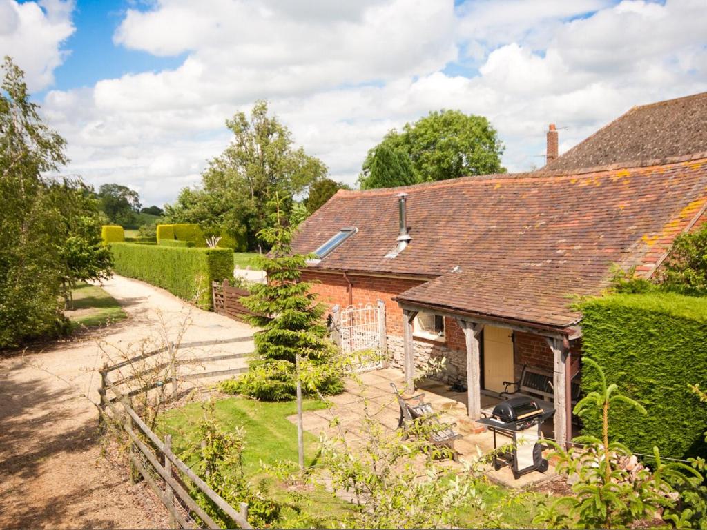 an old red brick house with a garden at Rye Court Cottage in Birtsmorton