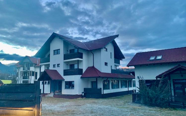 a large white house with red roofs at Vila Victory in Tohanu Nou