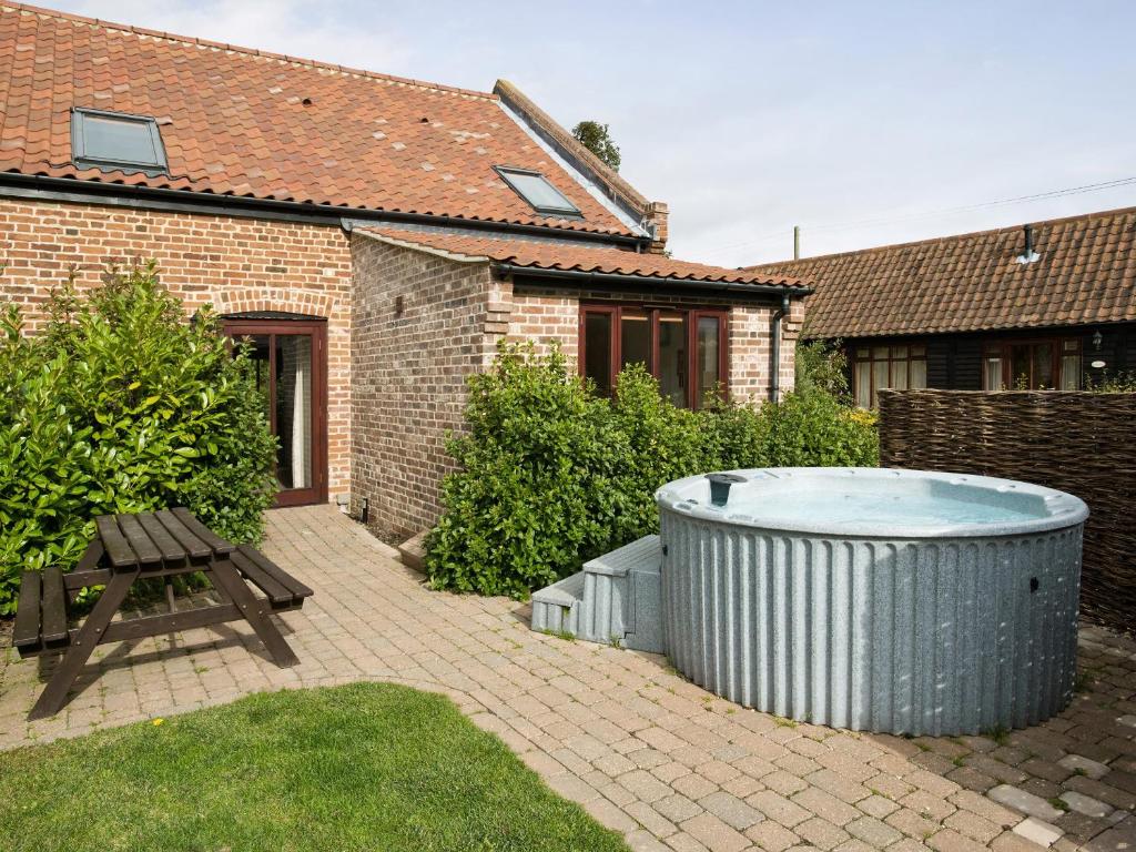 a hot tub in the backyard of a house at Coriander - E4323 in Ludham