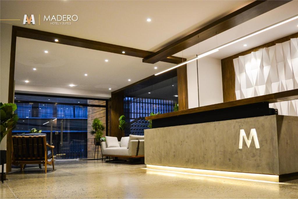 拉巴斯的住宿－Madero Hotel & Suites，墙上挂着m标志的大堂