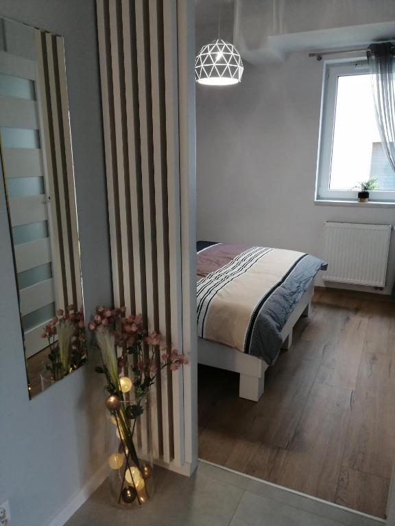 Postel nebo postele na pokoji v ubytování Apartament Zielone Wzgórze 2