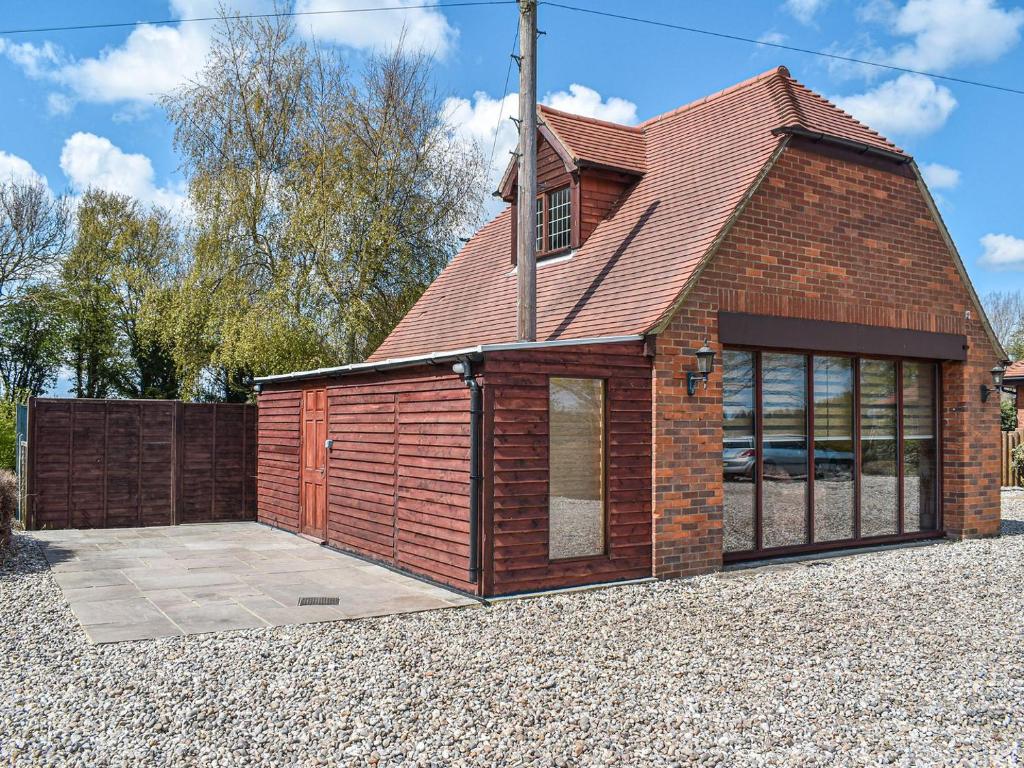 a small brick building with a garage at Leighwood in Sandwich