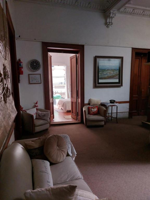 a living room with a couch and an open door at Hotel europeo in Buenos Aires