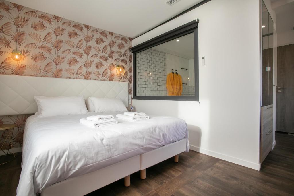 Posteľ alebo postele v izbe v ubytovaní Le Maleville - Appartements de Standing