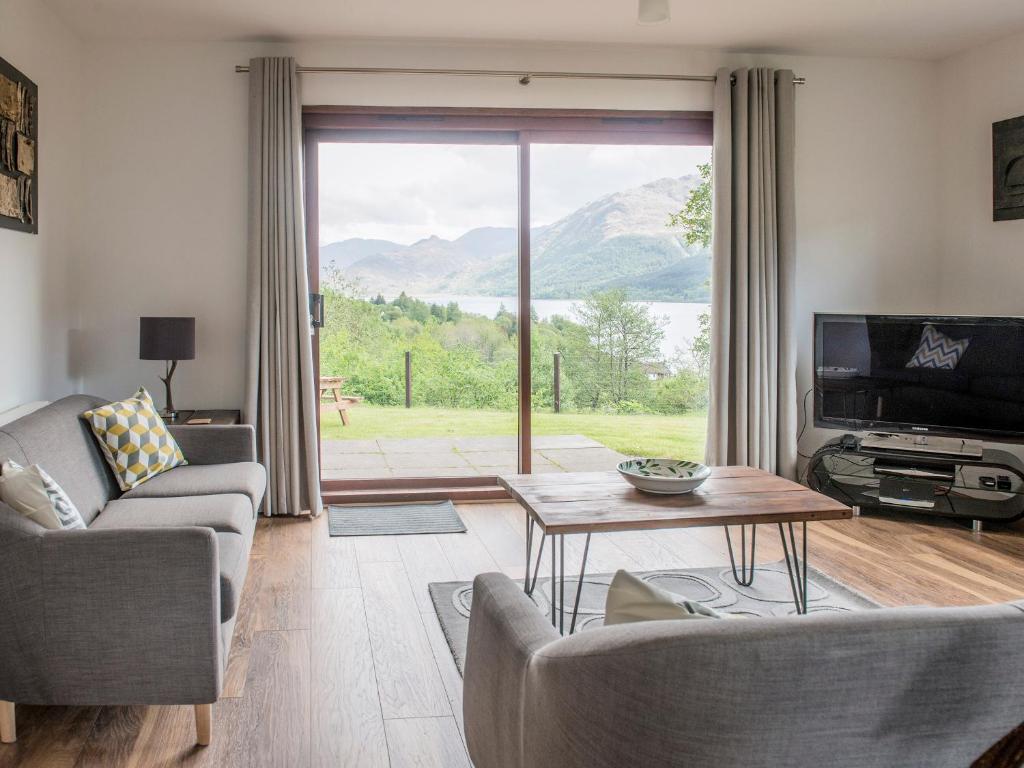 a living room with a view of a mountain at Rosdail in Inverinate