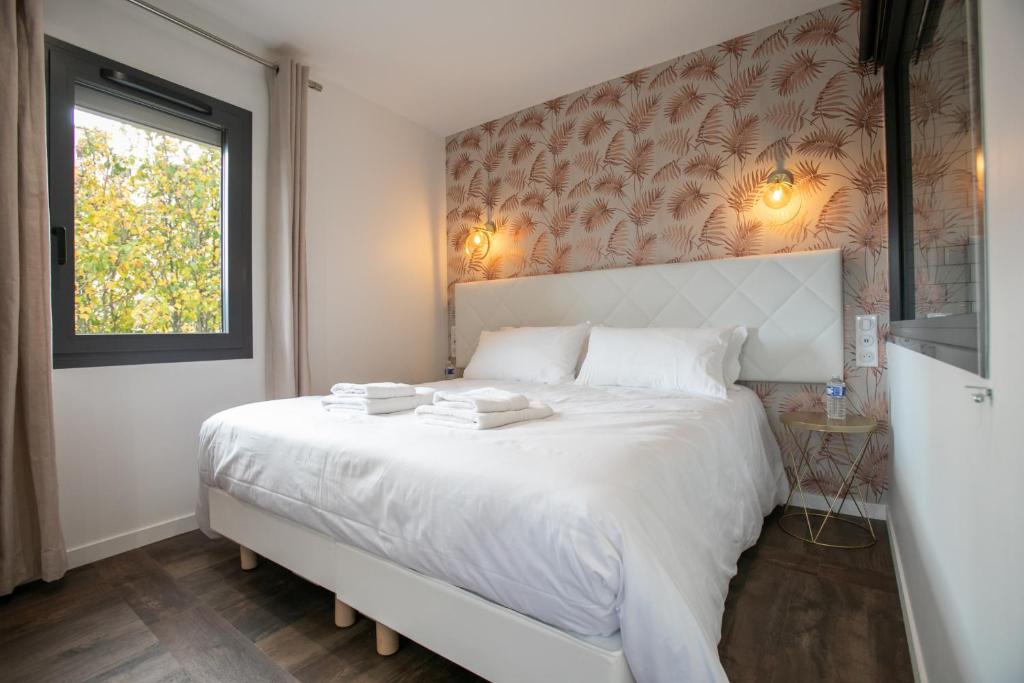 Posteľ alebo postele v izbe v ubytovaní Le Maleville - Appartements de Standing