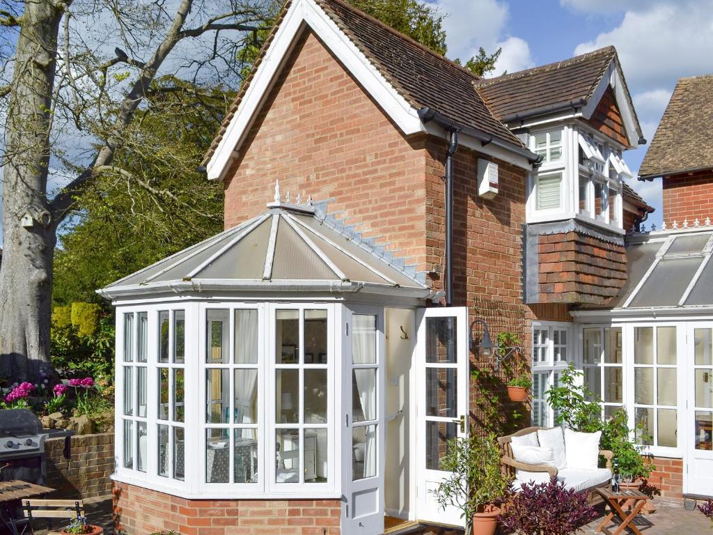 a extension to a house with a conservatory at The Studio in Cuckfield