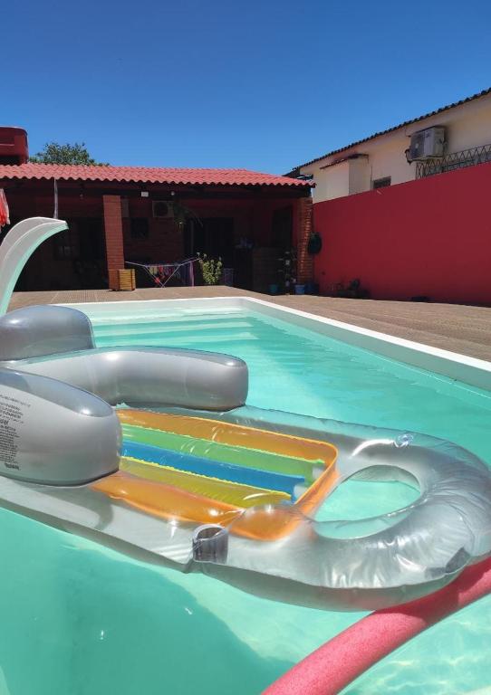 a swimming pool with an inflatable at Pousada da Dinda - Casa Familiar in São Gabriel