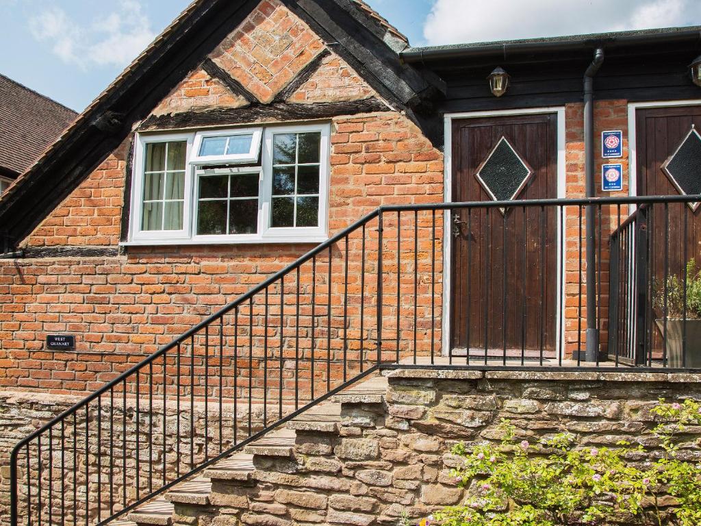 a brick house with a staircase leading to a door at West Granary - 28957 in Eye