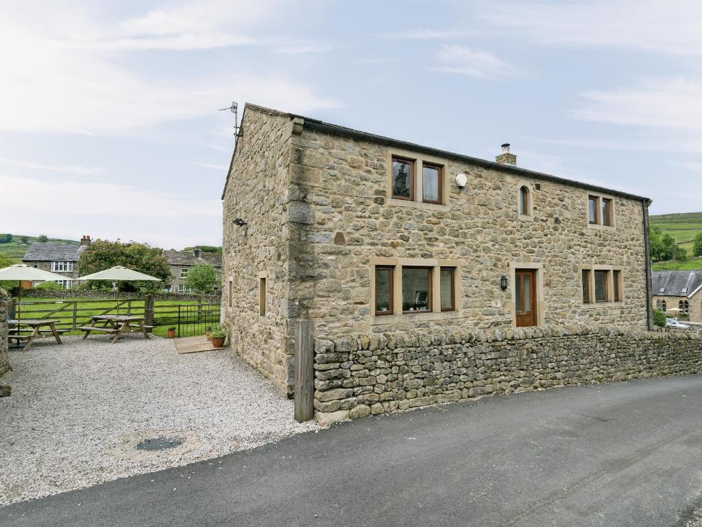 a stone house on the side of a road at Dipper Fold in Hebden