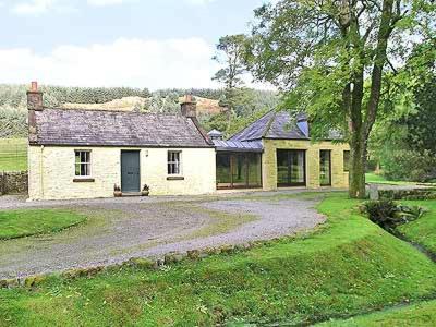 a large white house with a driveway in front of it at Marwhin Cottage - Swws in Kirkpatrick Durham