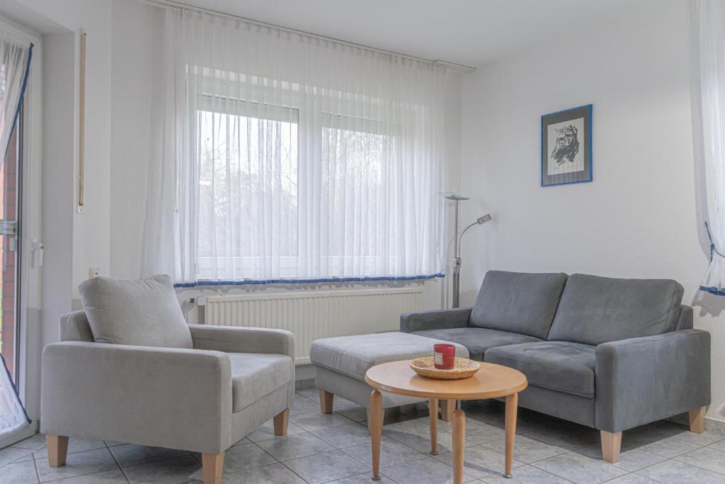 a living room with two chairs and a couch and a table at Nautilus in Zingst