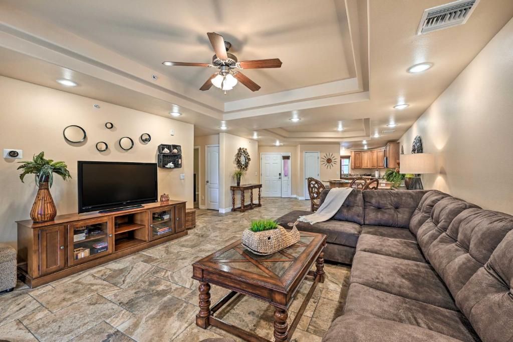 a living room with a couch and a flat screen tv at Step-Free Bullhead City Condo with Balcony! in Bullhead City